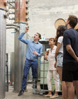 Guide explaining how the CIRKA stills work to a small group of visitors